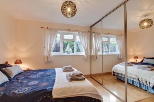 a bedroom with two beds and a mirror at 2 Bed in Staithes oc-wa071 in Staithes