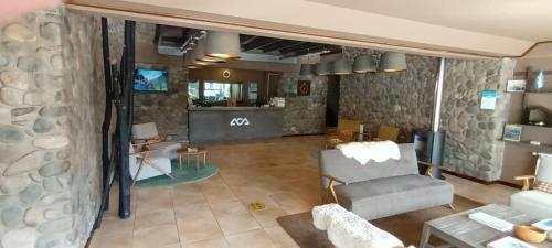 an overhead view of a living room with a chair and a table at Hotel ACA El Calafate in El Calafate
