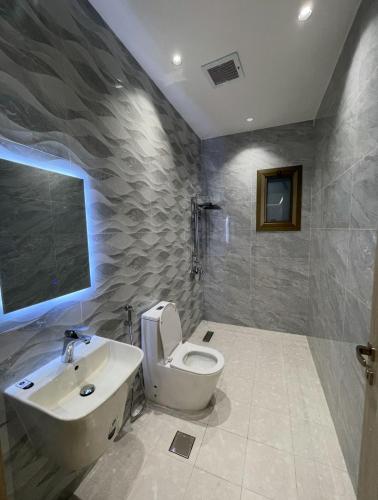 a bathroom with a toilet and a sink at O2P Al Salam in Medina