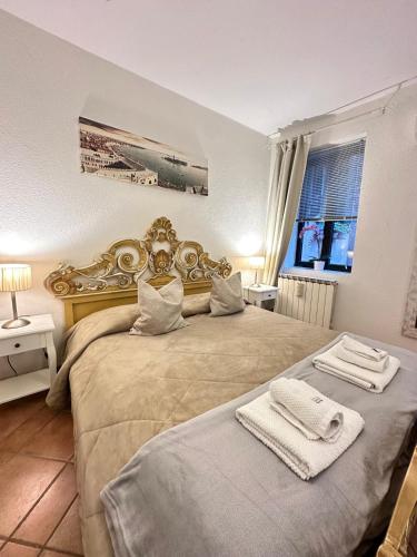 a bedroom with a large bed with towels on it at Caterina Biennale Apartment in Venice