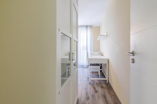 a white room with a desk and a mirror at AYZ Villegas - Auto check-in property in Madrid
