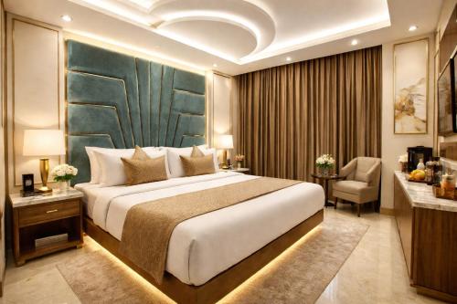 a hotel room with a large bed and a desk at Hotel Star Villa City Centre Connaught Place - Airport Pick Up & Drop in New Delhi