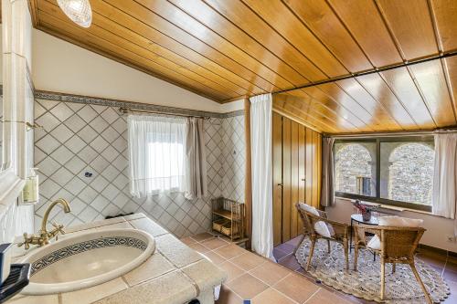 a bathroom with a tub and a table in it at Can Barrull-Costa Brava-Emporda in San Felíu de Boada