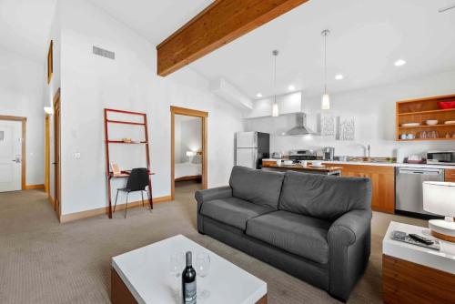 a living room with a couch and a kitchen at Front Street Suites - Pacific Retreats in Leavenworth