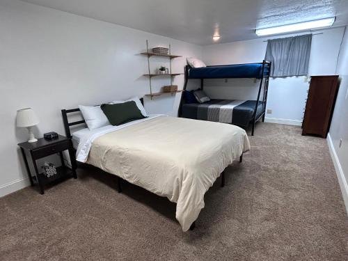 a bedroom with a bed and a chair in it at Sunny Days! Room for All and Pet Friendly in Pocatello