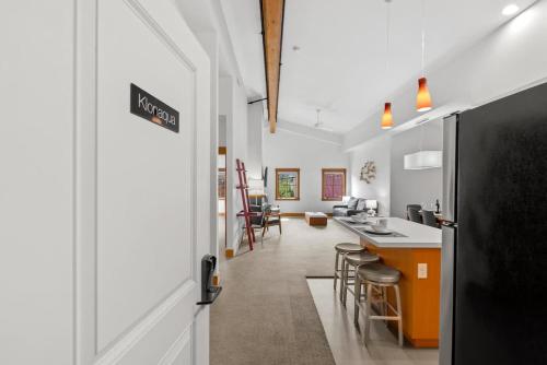 a kitchen and living room with a counter and chairs at Klonaqua - Pacific Retreats in Leavenworth