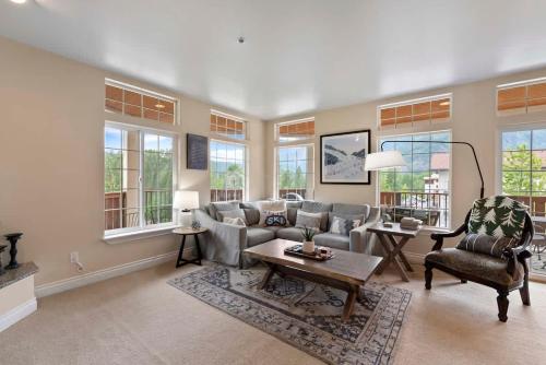 a living room with a couch and chairs and windows at Apres Ski Chalet - Pacific Retreats in Leavenworth