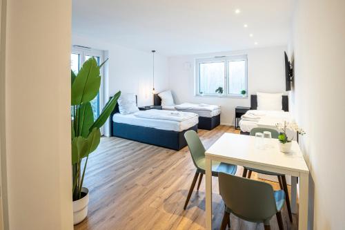a living room with a bed and a table at Montelio Living in Ettlingen