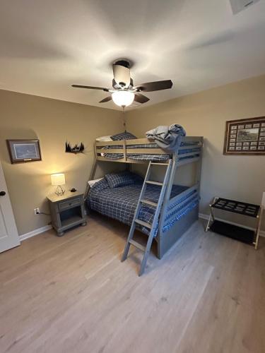 a bedroom with bunk beds and a ceiling fan at KSK Getaway in Nekoosa