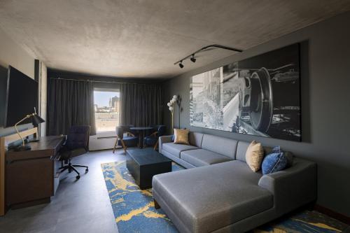 a living room with a couch and a desk at Bally's Baton Rouge Hotel in Baton Rouge