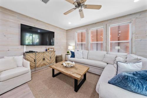 a living room with a couch and a table at Lil Js Getaway at Romeo Beach #3 by Youngs Suncoast in Gulf Shores