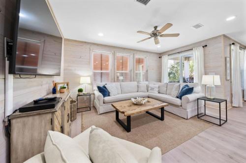 a living room with a couch and a table at Lil Js Getaway at Romeo Beach #3 by Youngs Suncoast in Gulf Shores