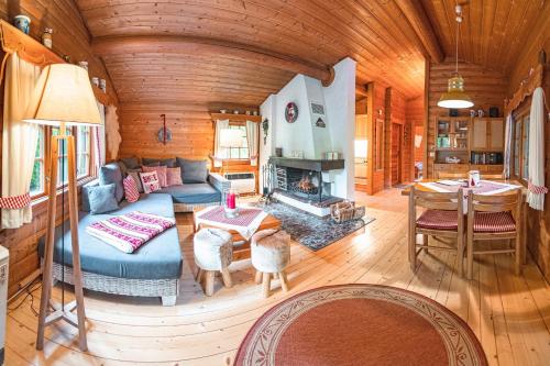 a living room with a couch and a table and a fireplace at Schwedenhaus Kaminzauber in Bömighausen