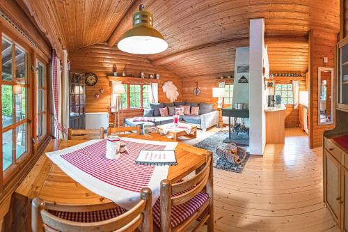 a dining room and living room in a log cabin at Schwedenhaus Kaminzauber in Bömighausen
