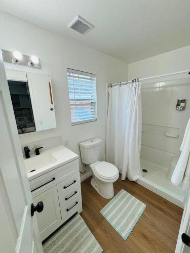 a white bathroom with a toilet and a shower at Cozy Villa with Spa, Fireplace, Kitchen, Yard, BBQ in Simi Valley