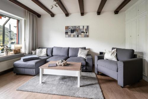 a living room with a couch and a coffee table at Chalet La Belle Willingen in Willingen