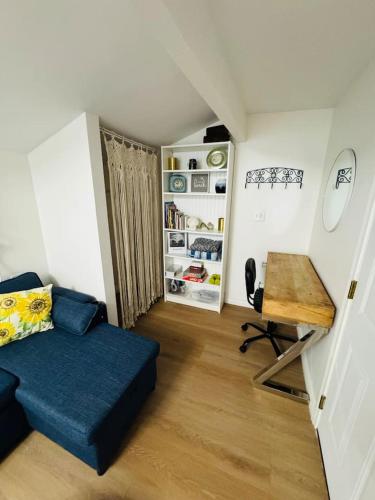 a living room with a couch and a table and a desk at Cozy Villa with Spa, Fireplace, Kitchen, Yard, BBQ in Simi Valley