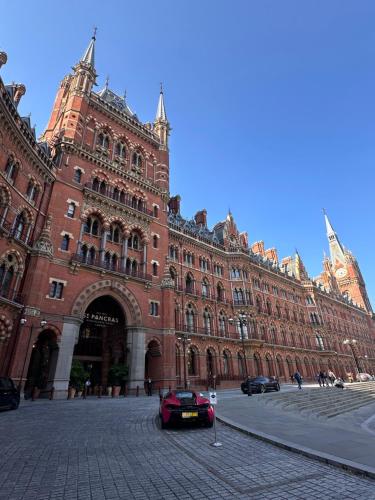 a car parked in front of a large building at Central Euston Station Studio - 1 minute walk in London