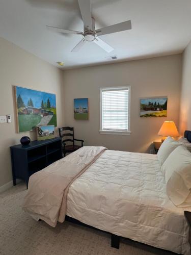 a bedroom with a bed and a ceiling fan at Endicott Cottage in Richmond