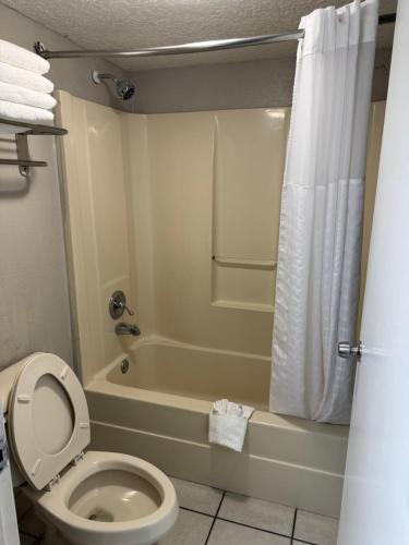 a bathroom with a toilet and a tub and a shower at Quality Inn Crystal River in Crystal River