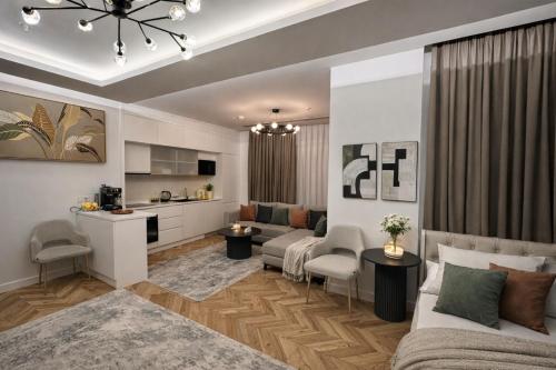 a living room with a couch and a kitchen at NestOne - Apartment hotels in Tashkent