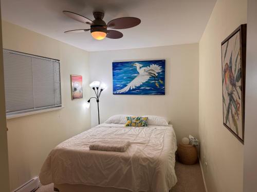 a bedroom with a bed and a ceiling fan at Langley Suite with Full Kitchen in Langley