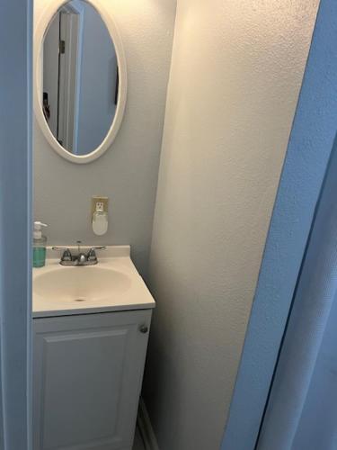 a bathroom with a sink and a mirror at Trisuites 2 in New Orleans
