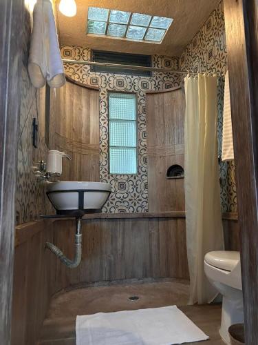 a bathroom with a sink and a toilet at El Bungalow de Juana in Tepoztlán