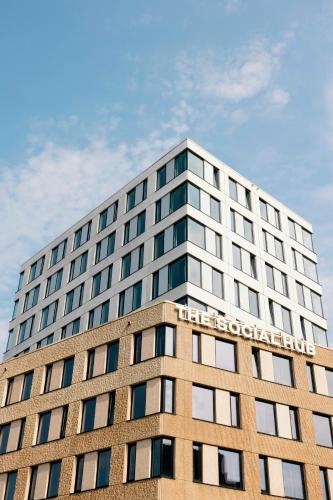 a tall building with a sign on the top of it at The Social Hub Delft Extended Stay in Delft