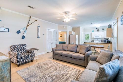 a living room with a couch and chairs and a kitchen at Orange Beach Villas - Allure by Youngs Suncoast in Orange Beach