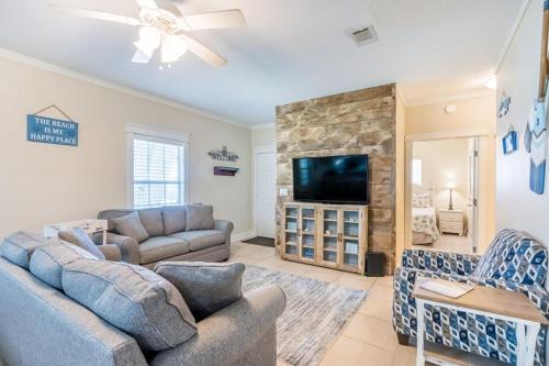 a living room with two couches and a flat screen tv at Orange Beach Villas - Allure by Youngs Suncoast in Orange Beach