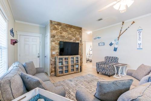 a living room with two couches and a flat screen tv at Orange Beach Villas - Allure by Youngs Suncoast in Orange Beach