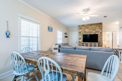 a living room with a table and chairs and a couch at Orange Beach Villas - Allure by Youngs Suncoast in Orange Beach