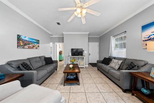 a living room with couches and a ceiling fan at Orange Beach Villas - Beach Retreat by Youngs Suncoast in Orange Beach