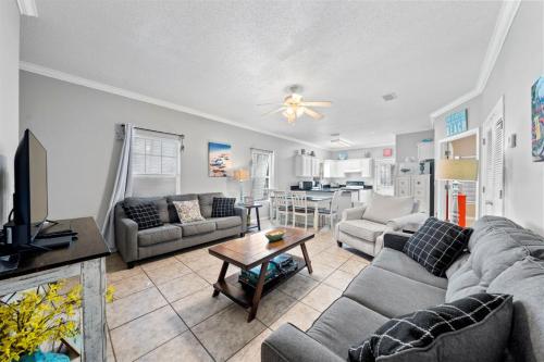 a living room with a couch and a table at Orange Beach Villas - Beach Retreat by Youngs Suncoast in Orange Beach
