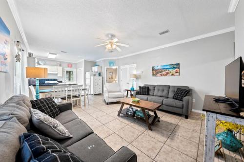 a living room with a couch and a table at Orange Beach Villas - Beach Retreat by Youngs Suncoast in Orange Beach