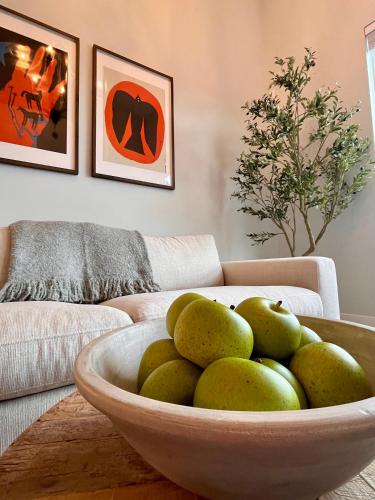 a bowl of pears in a living room with a couch at Modern & Stylish Condo in Langley City in Langley