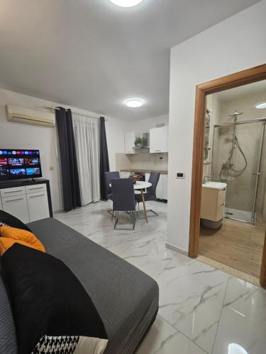 a living room with a bed and a dining room at Apartment Mary in Trogir