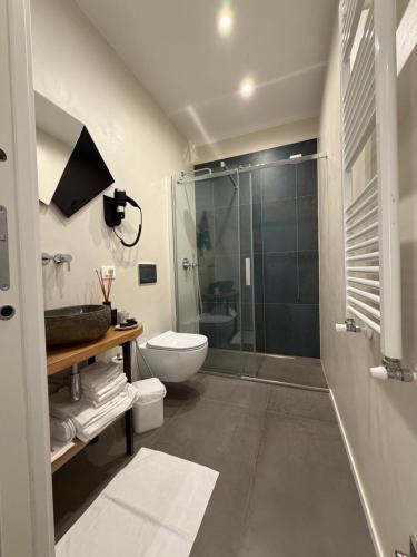 a bathroom with a toilet and a glass shower at Oblò Portovenere Guesthouse in Portovenere
