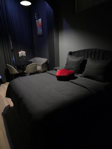 a bedroom with a bed with a red pillow on it at KALI Old Town LOFT with Monument view in Bucharest