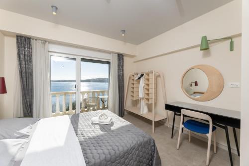 a bedroom with a bed and a desk and a window at SEGET ESTATE Beachfront Oasis & Tradition since 1964 - Split Trogir Riviera in Trogir