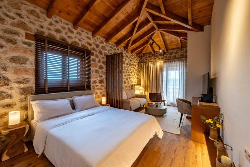 a bedroom with a large bed and a living room at Levanta Guesthouse in Synikia Mesi Trikalon