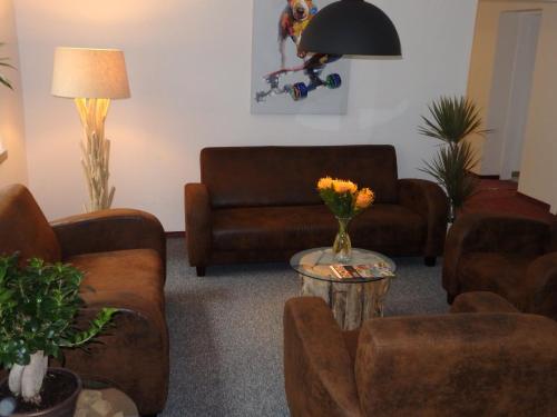 a living room with a couch and a table with flowers at Zur Saale in Weißenfels