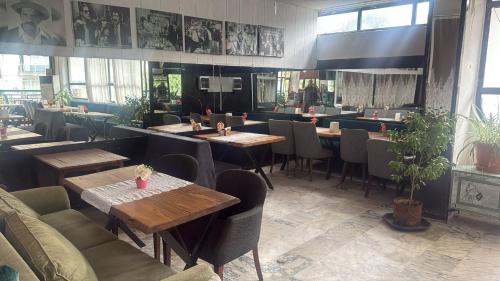 a restaurant with tables and chairs in a room at Sürücü oteli in Milas