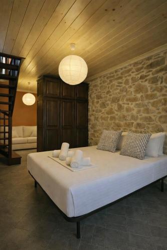 a bedroom with a large bed with towels on it at Elia & Petra Villa in Prinos