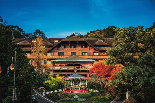 a large building with a gazebo in front of it at Casa da Montanha in Gramado