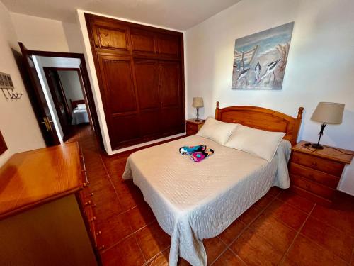 a bedroom with a bed with a pair of shoes on it at Lupita's House in Punta Mujeres