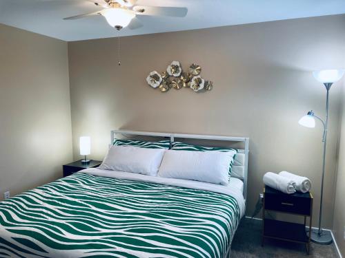 a bedroom with a bed and a ceiling fan at Welcome to Shibly's Retreat in Edmonton