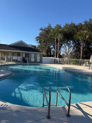 a large swimming pool with blue water in front of a house at Luxury 5 Bedroom Villa with Secluded Pool/Spa in Glenbrook community near Orlando in Orlando