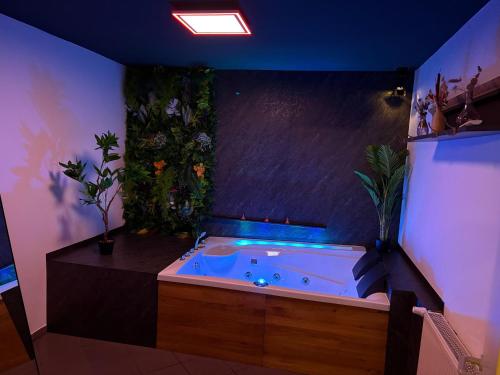 a jacuzzi tub in a room with plants at Wellnesshaus - Whirlpool - Sauna - Relax in Herten